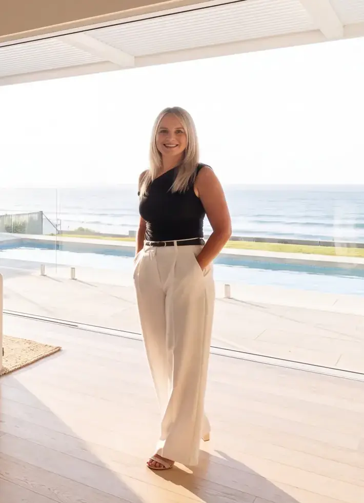 Brandi Wilson, Managing Director of Property Management at ELITE Lifestyle Properties, in a light-filled coastal home overlooking the ocean