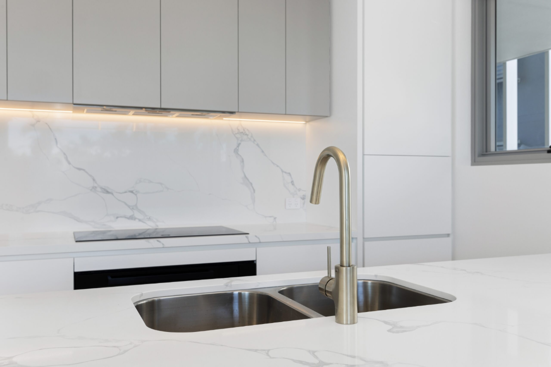 Stone benchtop and cabinetry detail in the kitchen of Residence 202, Ocean Rise Kings Beach