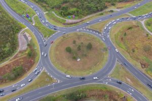 Aerial photograph of the existing Caloundra Road, Kawana Way Link Road and Bells Creek Arterial Road roundabout before the proposed interchange upgrade.